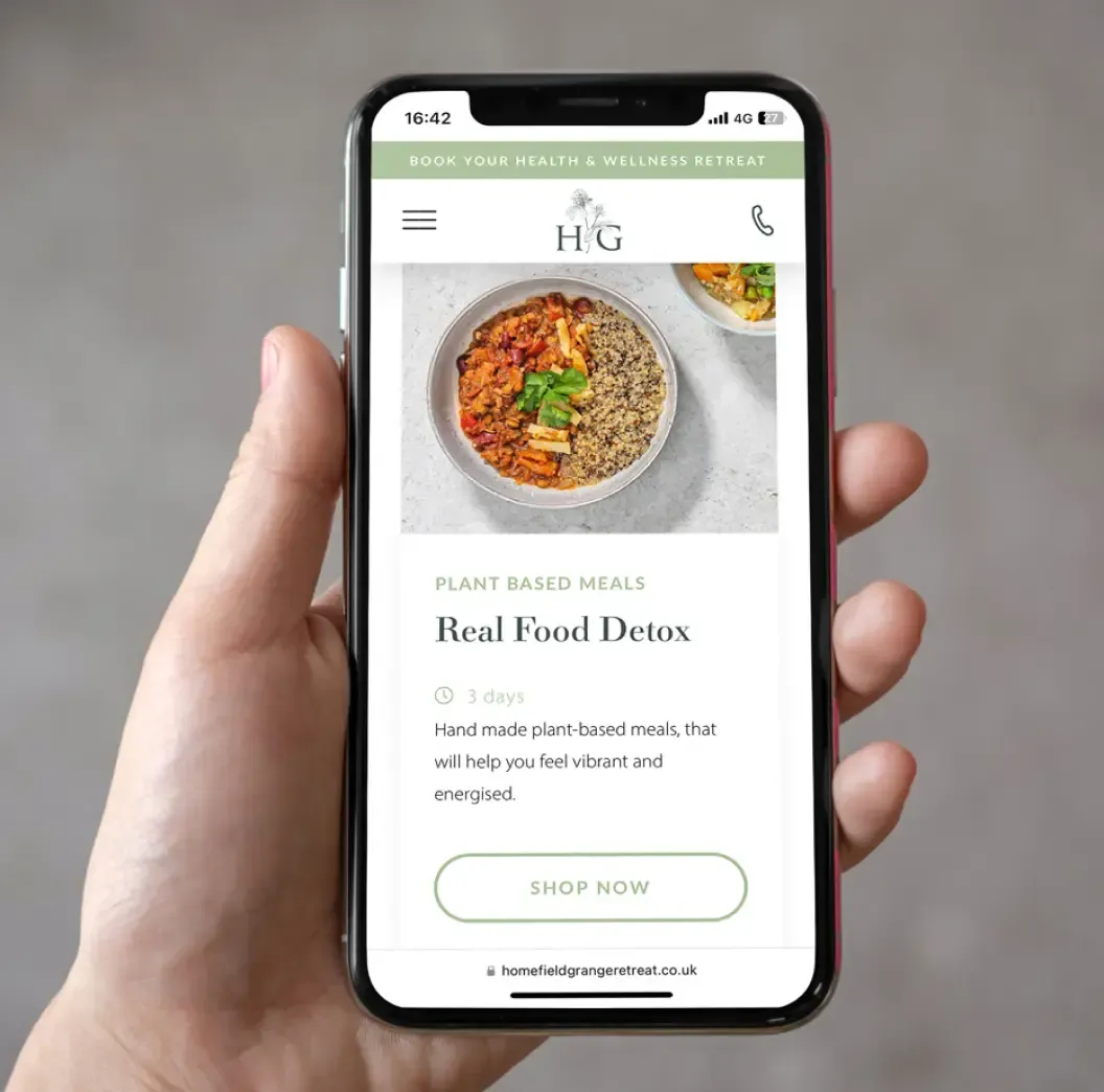 Hand holding mobile with Homefield Grange detox and weight loss at home website