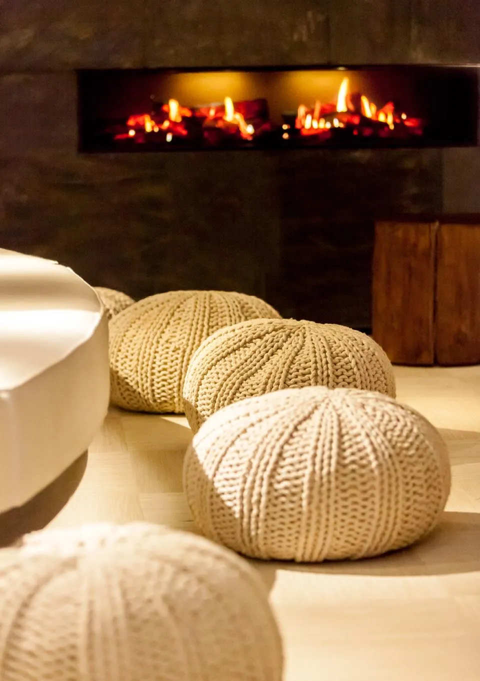 Cosy spa lounge with open fire and natural textures at Champneys Forest Mere