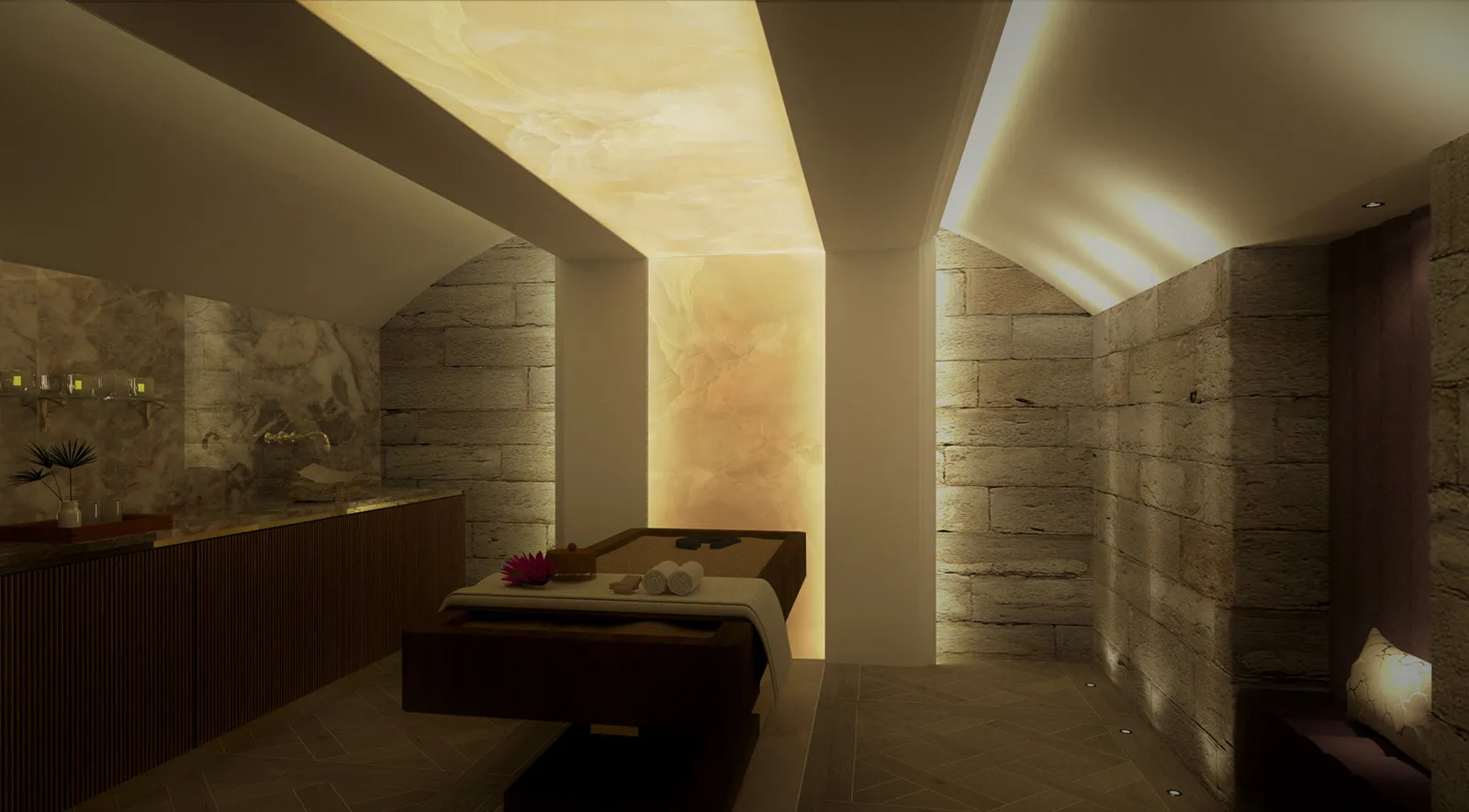 Basement spa treatment space at Dromoland Castle featuring arched ceilings, warm backlit onyx panels and calming natural stone finishes