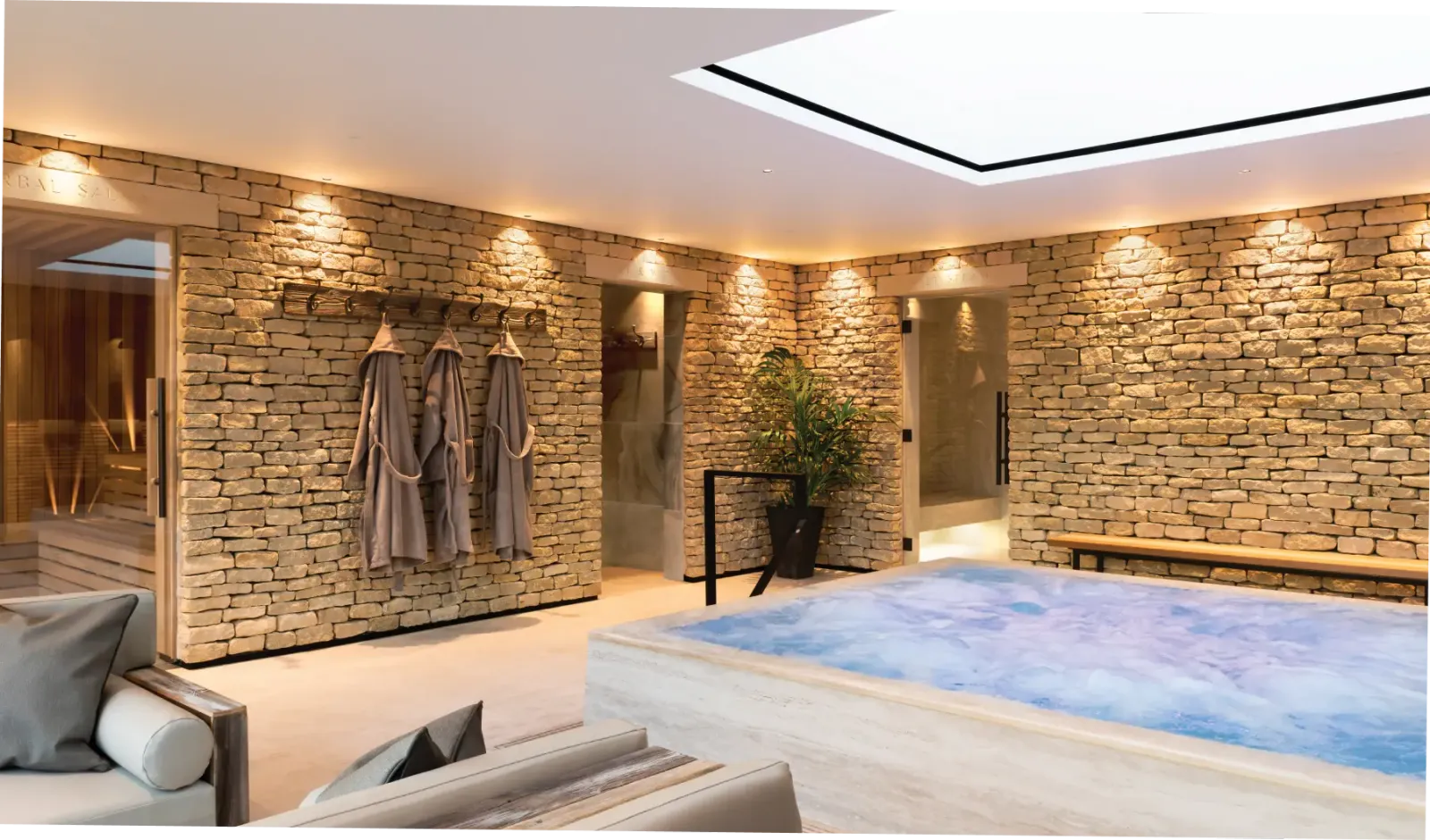 Hydrotherapy pool within thermal spa at Homefield Grange, showing natural stone materials and spa guest journey layout