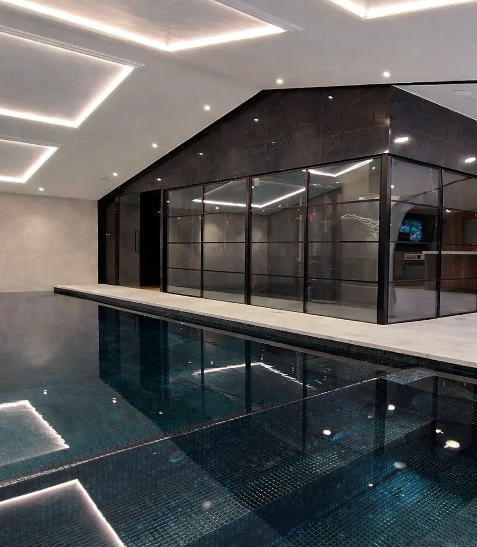Luxury residential spa design with indoor pool, glass-fronted wellness suite and contemporary lighting by Butterscotch Design